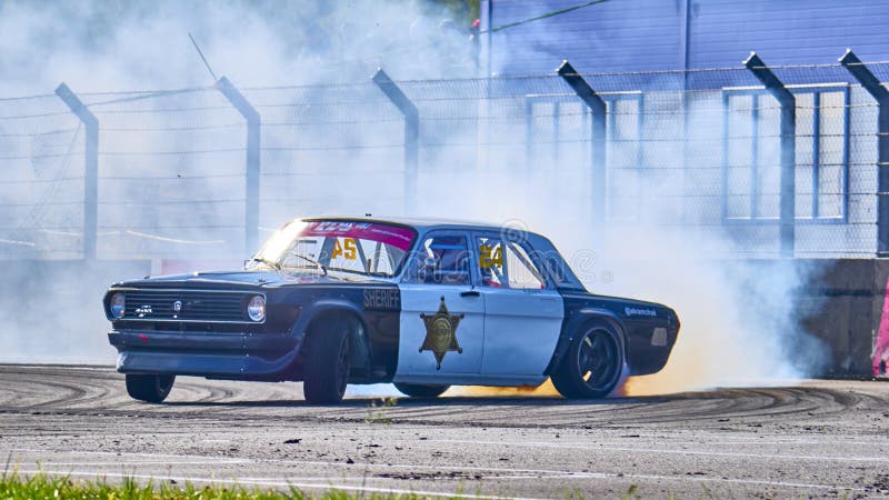 Russia Ryazan International Track Atron September 2020. A sports car in a controlled skid on the track. Smoke billows from under the wheels. Russia Ryazan International Track Atron September 2020. A sports car in a controlled skid on the track. Smoke billows from under the wheels