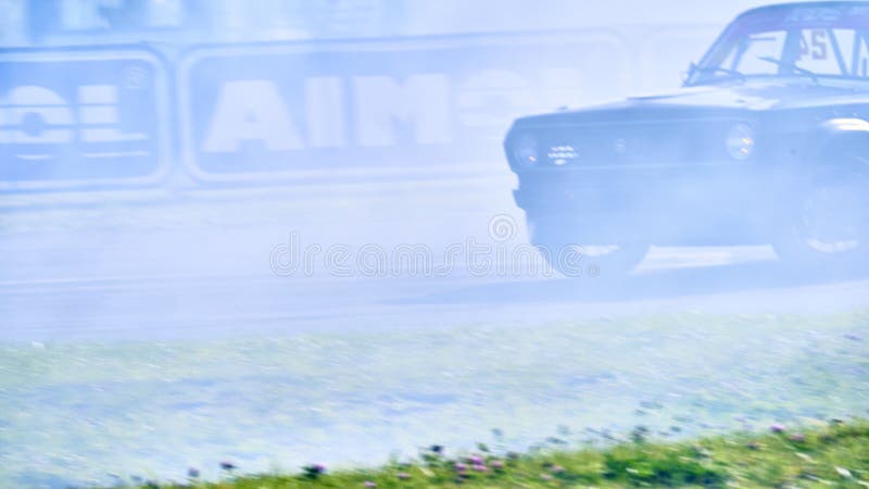 Russia Ryazan International Track Atron September 2020. A sports car in a controlled skid on the track. Smoke billows from under the wheels. Russia Ryazan International Track Atron September 2020. A sports car in a controlled skid on the track. Smoke billows from under the wheels