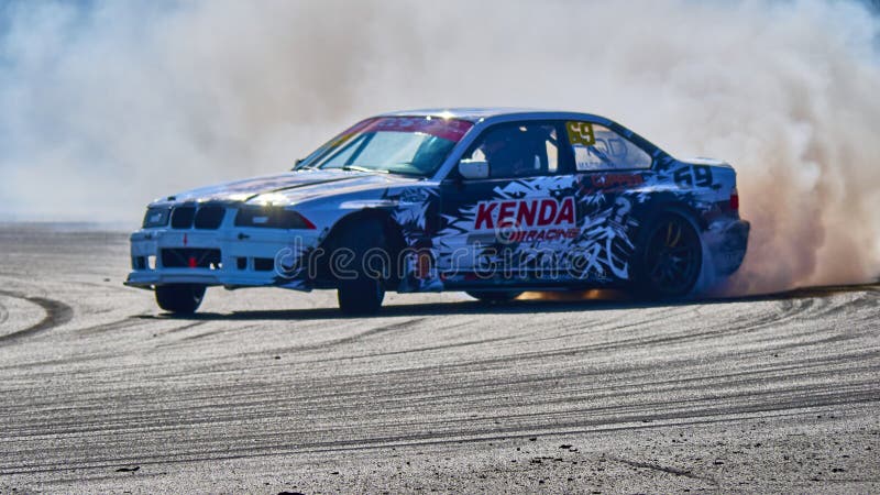 Russia Ryazan International Track Atron September 2020. A sports car in a controlled skid on the track. Smoke billows from under the wheels. Russia Ryazan International Track Atron September 2020. A sports car in a controlled skid on the track. Smoke billows from under the wheels