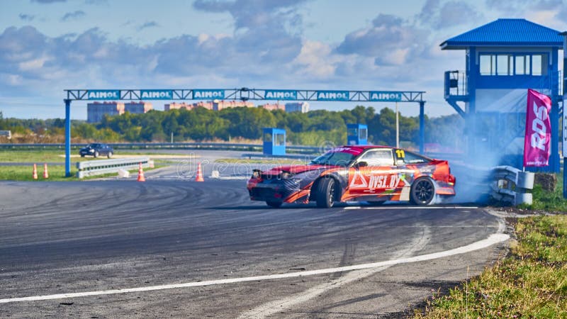 Russia Ryazan International Track Atron September 2020. A sports car in a controlled skid on the track. Smoke billows from under the wheels. Russia Ryazan International Track Atron September 2020. A sports car in a controlled skid on the track. Smoke billows from under the wheels