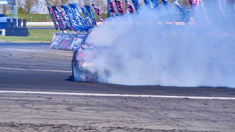 Russia Ryazan International Track Atron September 2020. A sports car in a controlled skid on the track. Smoke billows from under the wheels. Russia Ryazan International Track Atron September 2020. A sports car in a controlled skid on the track. Smoke billows from under the wheels