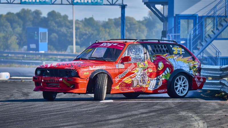 Russia Ryazan International Track Atron September 2020. A sports car in a controlled skid on the track. Smoke billows from under the wheels. Russia Ryazan International Track Atron September 2020. A sports car in a controlled skid on the track. Smoke billows from under the wheels