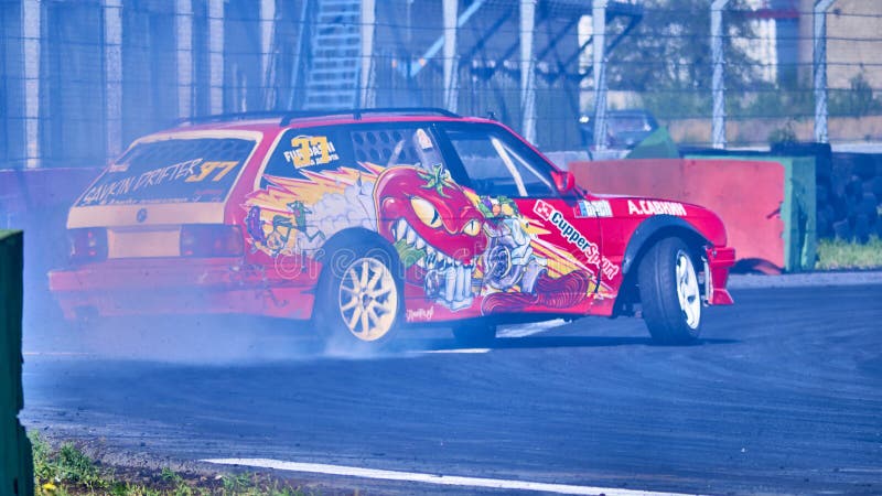 Russia Ryazan International Track Atron September 2020. A sports car in a controlled skid on the track. Smoke billows from under the wheels. Russia Ryazan International Track Atron September 2020. A sports car in a controlled skid on the track. Smoke billows from under the wheels