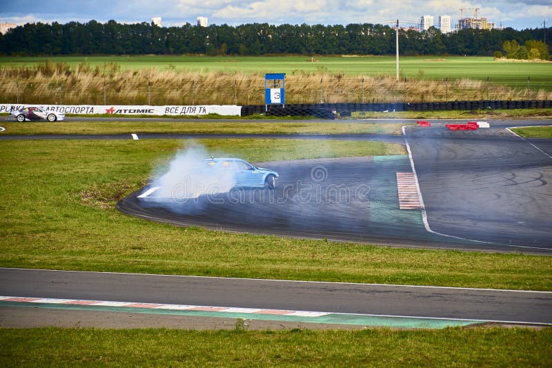 Russia Ryazan International Track Atron September 2020. A sports car in a controlled skid on the track. Smoke billows from under the wheels. Russia Ryazan International Track Atron September 2020. A sports car in a controlled skid on the track. Smoke billows from under the wheels