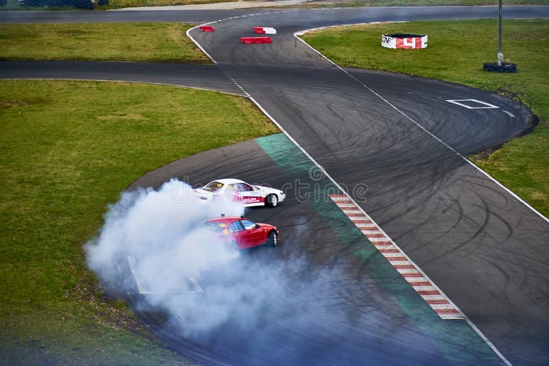 Russia Ryazan International Track Atron September 2020. A sports car in a controlled skid on the track. Smoke billows from under the wheels. Russia Ryazan International Track Atron September 2020. A sports car in a controlled skid on the track. Smoke billows from under the wheels