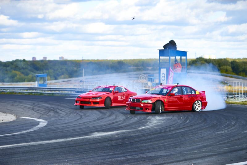 Russia Ryazan International Track Atron September 2020. A sports car in a controlled skid on the track. Smoke billows from under the wheels. Russia Ryazan International Track Atron September 2020. A sports car in a controlled skid on the track. Smoke billows from under the wheels