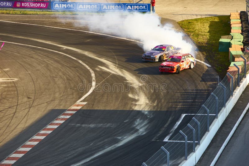 Russia Ryazan International Track Atron September 2020. A sports car in a controlled skid on the track. Smoke billows from under the wheels. Russia Ryazan International Track Atron September 2020. A sports car in a controlled skid on the track. Smoke billows from under the wheels