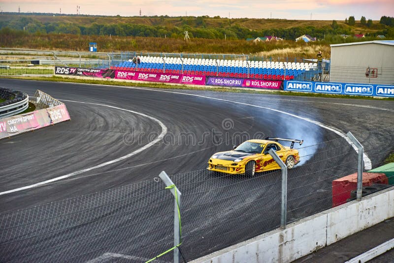 Russia Ryazan International Track Atron September 2020. A sports car in a controlled skid on the track. Smoke billows from under the wheels. Russia Ryazan International Track Atron September 2020. A sports car in a controlled skid on the track. Smoke billows from under the wheels