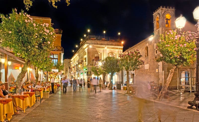 TAORMINA, ITALY - OCTOBER 1, 2012: The Square of IX Aprile is the best place for supper in luxury restaurant or cozy cafe, enjoy the views or walk to the central town promenade - Corso Umberto, on October 1 in Taormina. TAORMINA, ITALY - OCTOBER 1, 2012: The Square of IX Aprile is the best place for supper in luxury restaurant or cozy cafe, enjoy the views or walk to the central town promenade - Corso Umberto, on October 1 in Taormina.