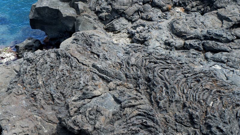 La superficie de la piedra volcánica Ennegrezca el fondo de piedra Oscile la textura Fondo de la pila de la roca imagen de archivo libre de regalías La superficie de la piedra volcánica Ennegrezca el fondo de piedra Oscile la textura Fondo de la pila de la roca imagen de archivo libre de regalías