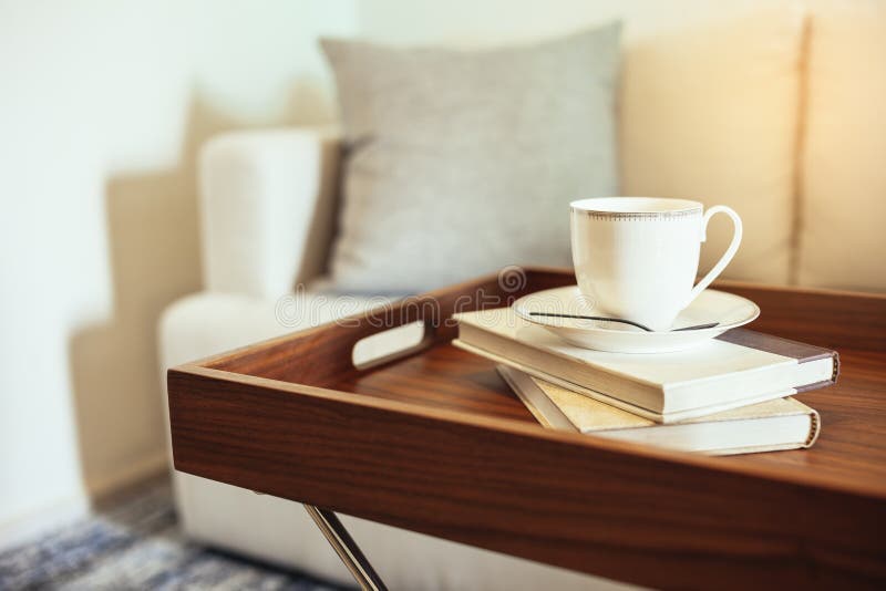 Coffee cup Books on table wooden tray Pillow on sofa Home Interior leisure lifestyle. Coffee cup Books on table wooden tray Pillow on sofa Home Interior leisure lifestyle