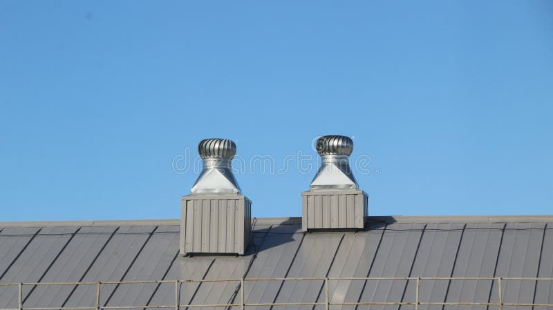 Shiny metal air ventilation on the roof rotates to clean the air in the building and regulate the temperature. Shiny metal air ventilation on the roof rotates to clean the air in the building and regulate the temperature