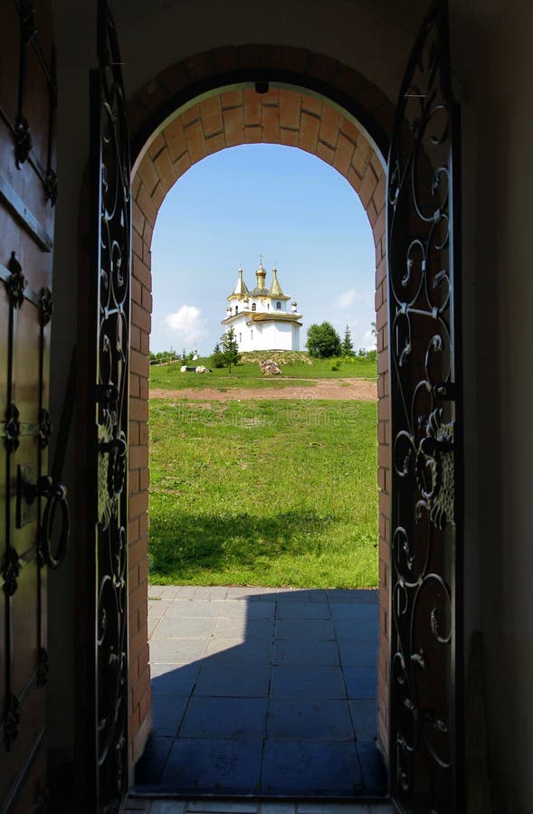 The view of the Orthodox Church through the gate. The view of the Orthodox Church through the gate.