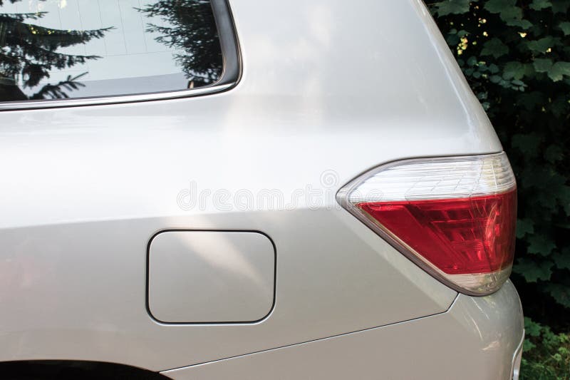 Side view of a car parked on the street with fuel opening. Mock-up for sticker or decals. Side view of a car parked on the street with fuel opening. Mock-up for sticker or decals.