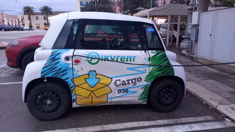 Charge station for electric cars on the street in Bari, Italy and a small car is charging. Charge station for electric cars on the street in Bari, Italy and a small car is charging