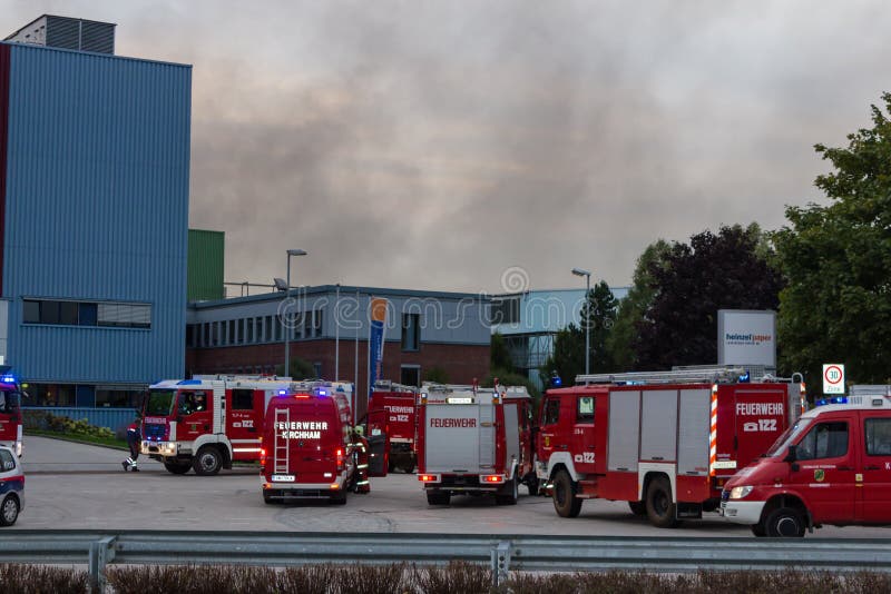 LAAKIRCHEN, AUSTRIA SEPTEMBER 24, 2015: Firefighters and fire truck with portable crane at fire in paper factory