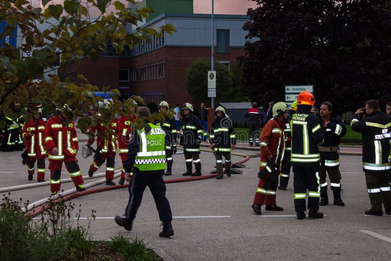 LAAKIRCHEN, AUSTRIA SEPTEMBER 24, 2015: Firefighters and fire truck with portable crane at fire in paper factory