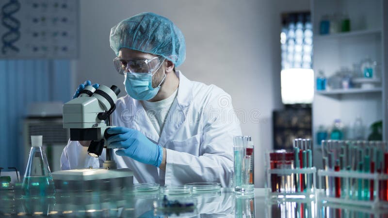 Lab assistant studying samples to detect pathologies, quality medical research stock photography Lab assistant studying samples to detect pathologies, quality medical research stock photography