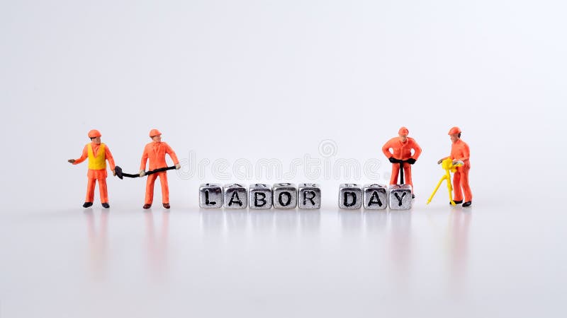 Labor day concept. Word labor day on metal cubes with miniature worker on white background