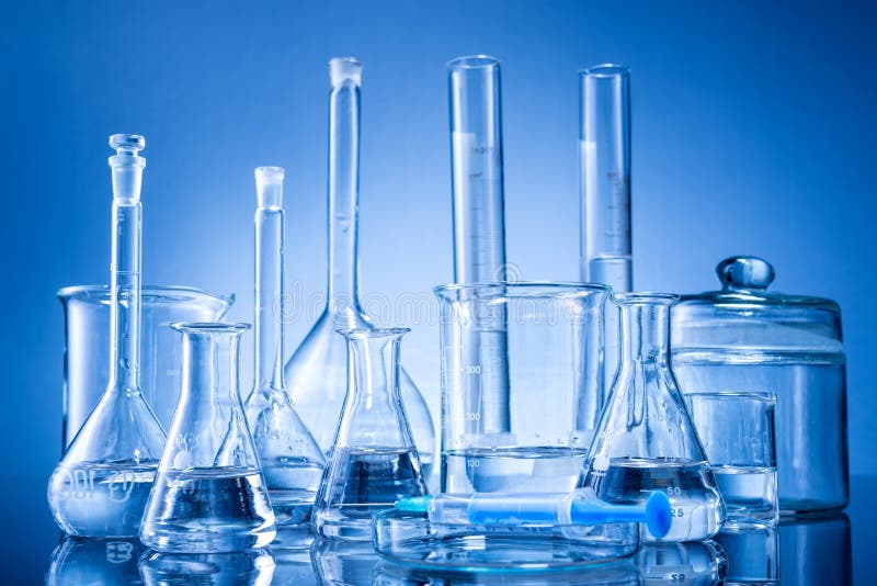 Laboratory equipment, bottles, flasks on blue background . Laboratory equipment, bottles, flasks on blue background .