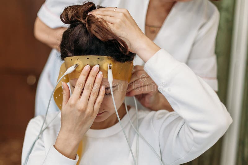 In Laboratorium zit de jonge vrouw die Brainwave-Aftastenhoofdtelefoon dragen als Voorzitter met Gesloten Ogen In Brain Neurologi royalty-vrije stock afbeelding In Laboratorium zit de jonge vrouw die Brainwave-Aftastenhoofdtelefoon dragen als Voorzitter met Gesloten Ogen In Brain Neurologi royalty-vrije stock afbeelding