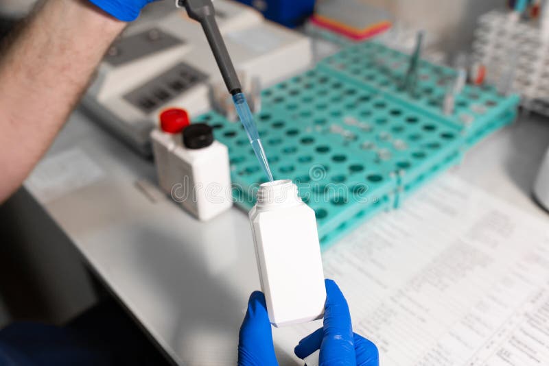 Laboratory Assistant Analyzing a Blood Sample Using Micropipette Stock