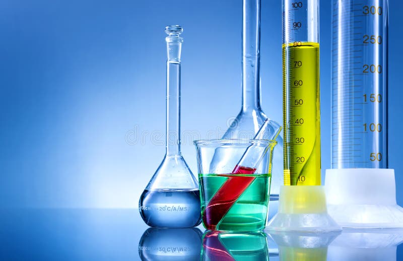 Laboratory equipment, bottles, flasks with color liquid on blue background