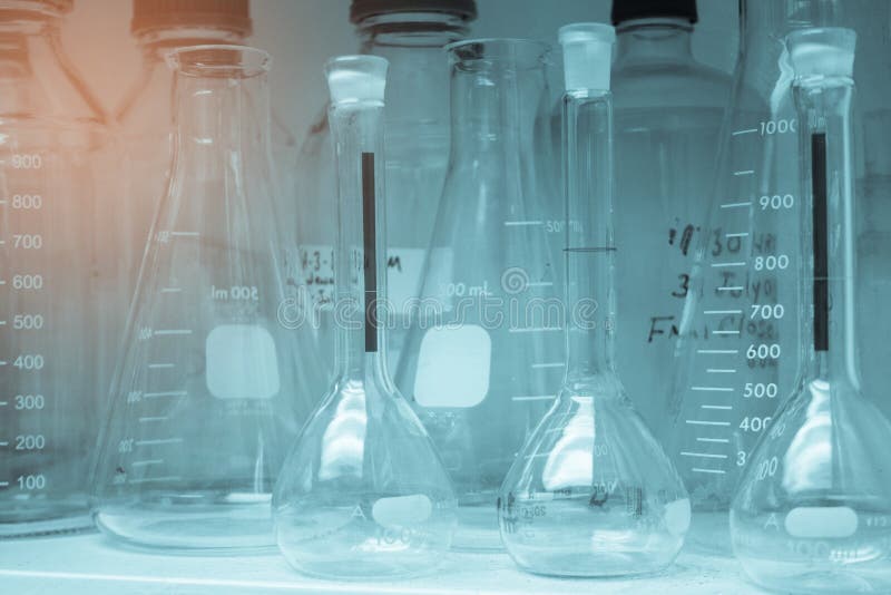 Laboratory Glassware or Beakers in Cold and Vintage Tone Stack on Shelf