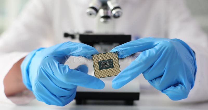 Laboratory technician sits at microscope examining specimen stock footage