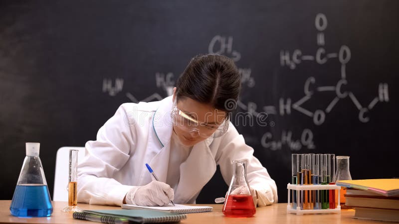 Laboratory worker writing down chemical research results, conducting experiments royalty free stock image Laboratory worker writing down chemical research results, conducting experiments royalty free stock image