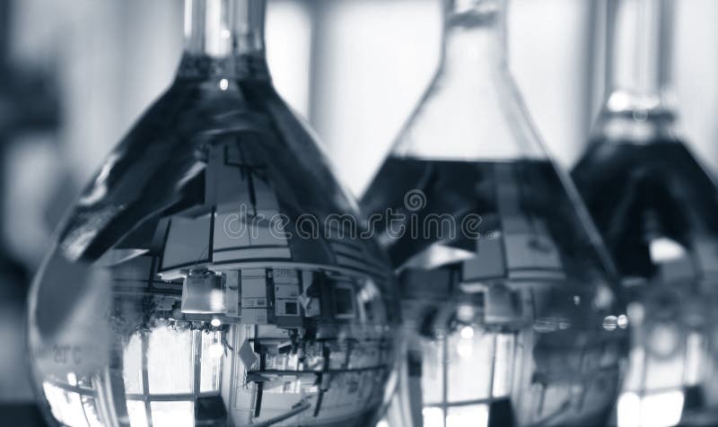 Volumetric flasks in medical laboratory. The first one has the lab image reflected upside down (a computer and some specific measurement devices). Duotone, it may be used for a scientific or medical project (see my portofolio for more medical related shots). Volumetric flasks in medical laboratory. The first one has the lab image reflected upside down (a computer and some specific measurement devices). Duotone, it may be used for a scientific or medical project (see my portofolio for more medical related shots).