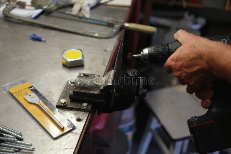 Laborer using an electric drill while metalworking stock photos Laborer using an electric drill while metalworking stock photos