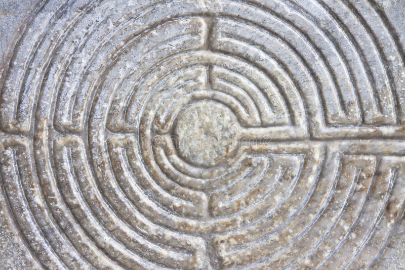 Labyrinth carved on the stone facade of a Romanesque church of the 11th century Tuscany - Italy. Labyrinth carved on the stone facade of a Romanesque church of the 11th century Tuscany - Italy.