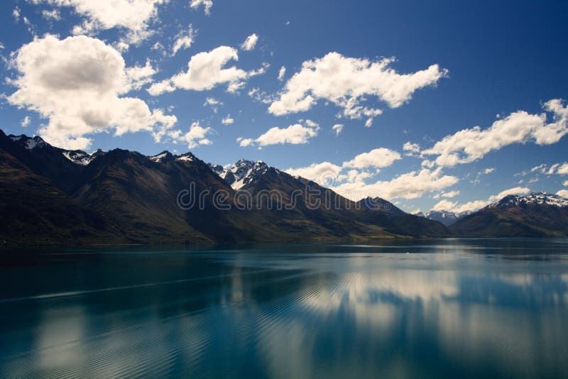 Reflection from Lake Wakatipu surrounded by mountains near Queenstown, South Island, New Zealand. Reflection from Lake Wakatipu surrounded by mountains near Queenstown, South Island, New Zealand