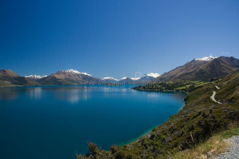 Scenic view of Lake Wakatipu with Southern Alps in background, South Island, New Zealand. Scenic view of Lake Wakatipu with Southern Alps in background, South Island, New Zealand.
