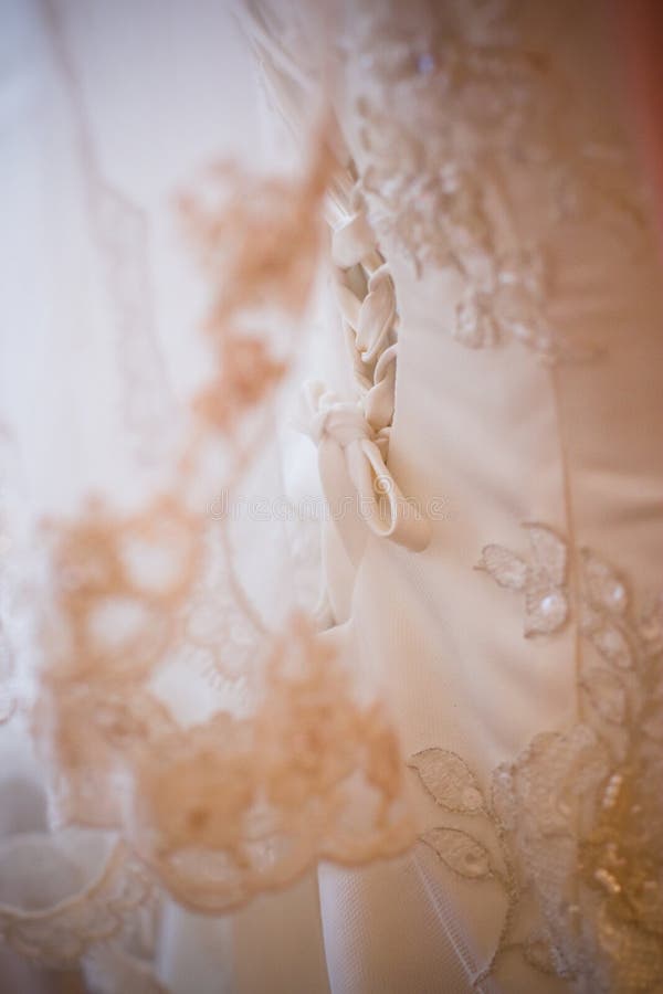 Lacing of the wedding dress stock photo