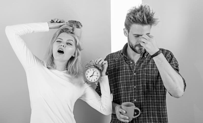Lack of sleep. Couple sleep not enough time. Family drink morning coffee yawning faces. Couple oversleep awakening hold stock photography Lack of sleep. Couple sleep not enough time. Family drink morning coffee yawning faces. Couple oversleep awakening hold stock photography
