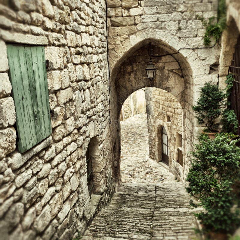 Medieval street in beautiful village of Lacoste after an evening rain. Lacoste is best known for its most notorious resident, Donatien Alphonse Francois comte de Sade, the Marquis de Sade. Filtered image
