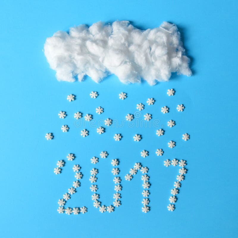 2017 loading with snowflakes falling from cotton clouds - Unique minimal flat lay design. 2017 loading with snowflakes falling from cotton clouds - Unique minimal flat lay design