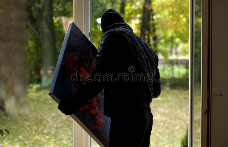 A thief holding a precious stolen painting. A thief holding a precious stolen painting
