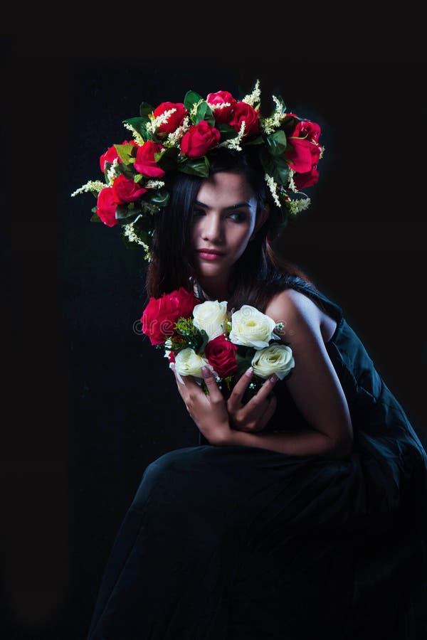 The lady in black dress with rose crown and rose bouquet,romantic style,art tone royalty free stock images The lady in black dress with rose crown and rose bouquet,romantic style,art tone royalty free stock images