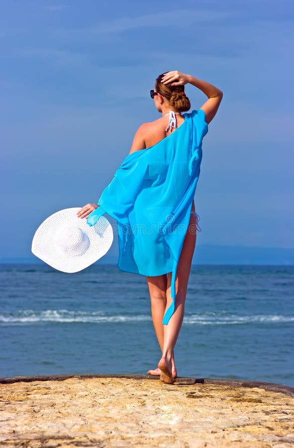 Lady in blue shawl on the beach