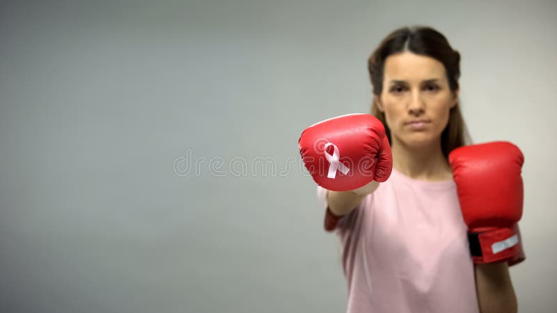 Lady in boxing gloves with pink ribbon, fighting breast cancer, social awareness