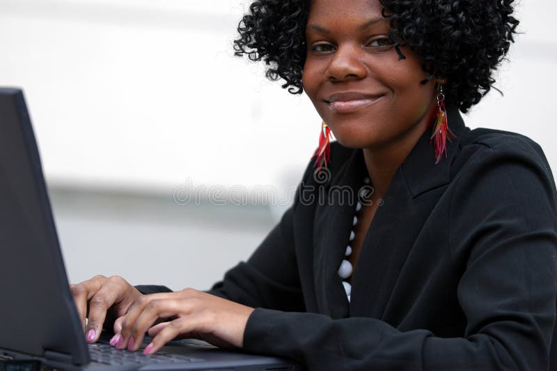Lady on computer smiles royalty free stock photography