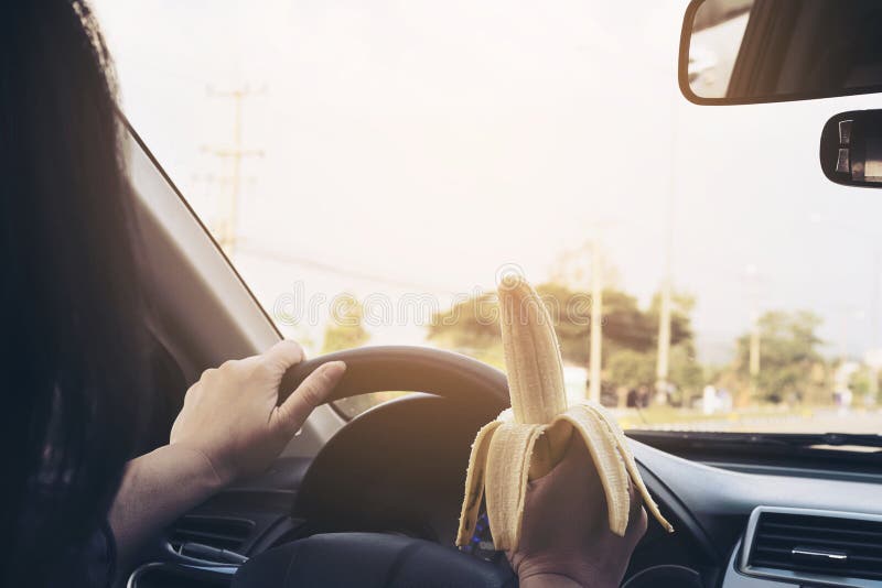Lady Eating Banana while Driving Car Stock Photo Image of highway