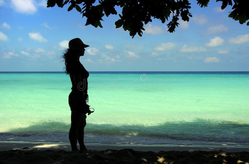 Lady figure with seascape background.