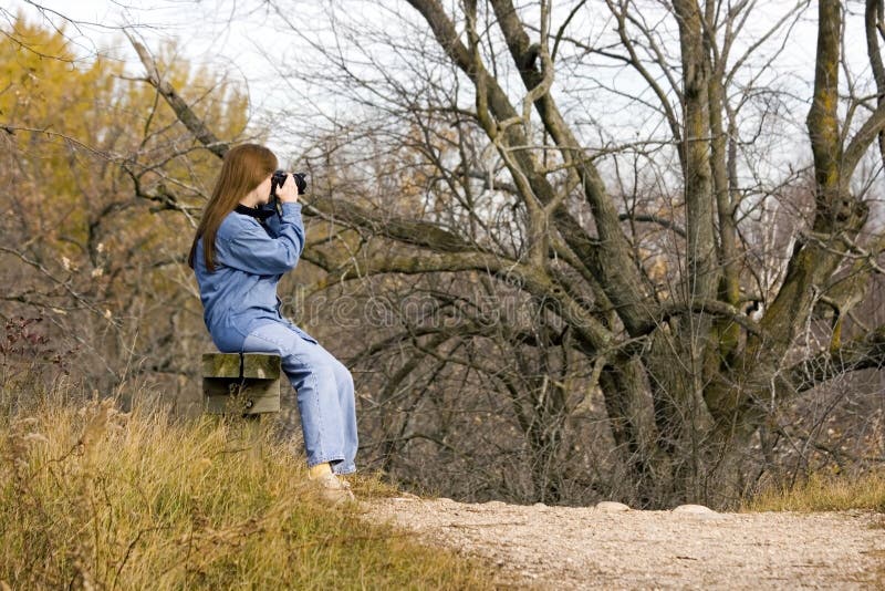 Lady hiker on the famed Ice Age Trail in Wisconsin taking a break and some photos. Lady hiker on the famed Ice Age Trail in Wisconsin taking a break and some photos.