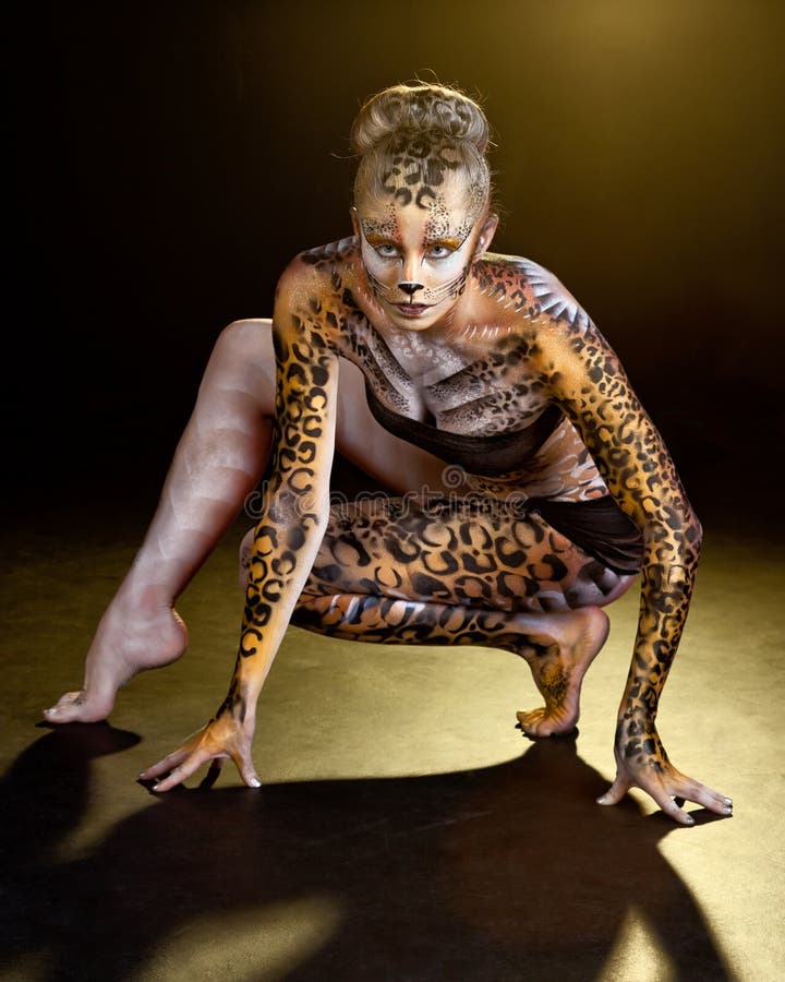 This is an image of a beautiful young dancer painted as a wild jungle leopa...