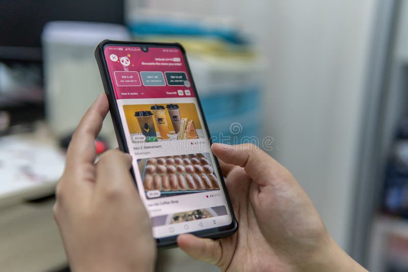 Kota Kinabalu, Sabah, Malaysia-June 15, 2021 : A lady ordering food using FOODPANDA apps. An Application foodpanda food delivery