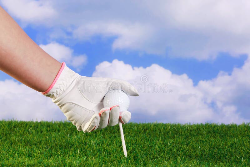 Ladies Golf Hand Placing Pink Tee and Ball into Ground. Stock Image